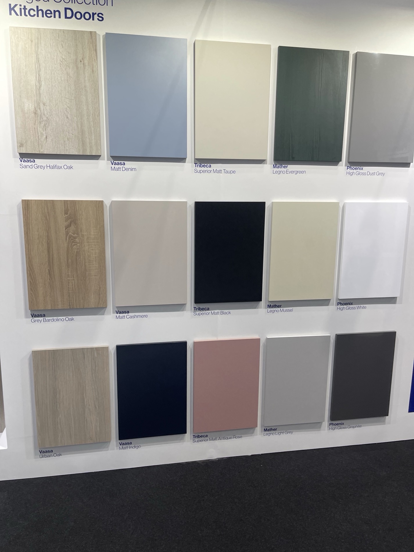 The door wall: matt, gloss, textured woodgrain and painted finishes side by side at full size. Colours behave very differently in the flesh, which is exactly why it's worth the trip to Peasmarsh before you decide.