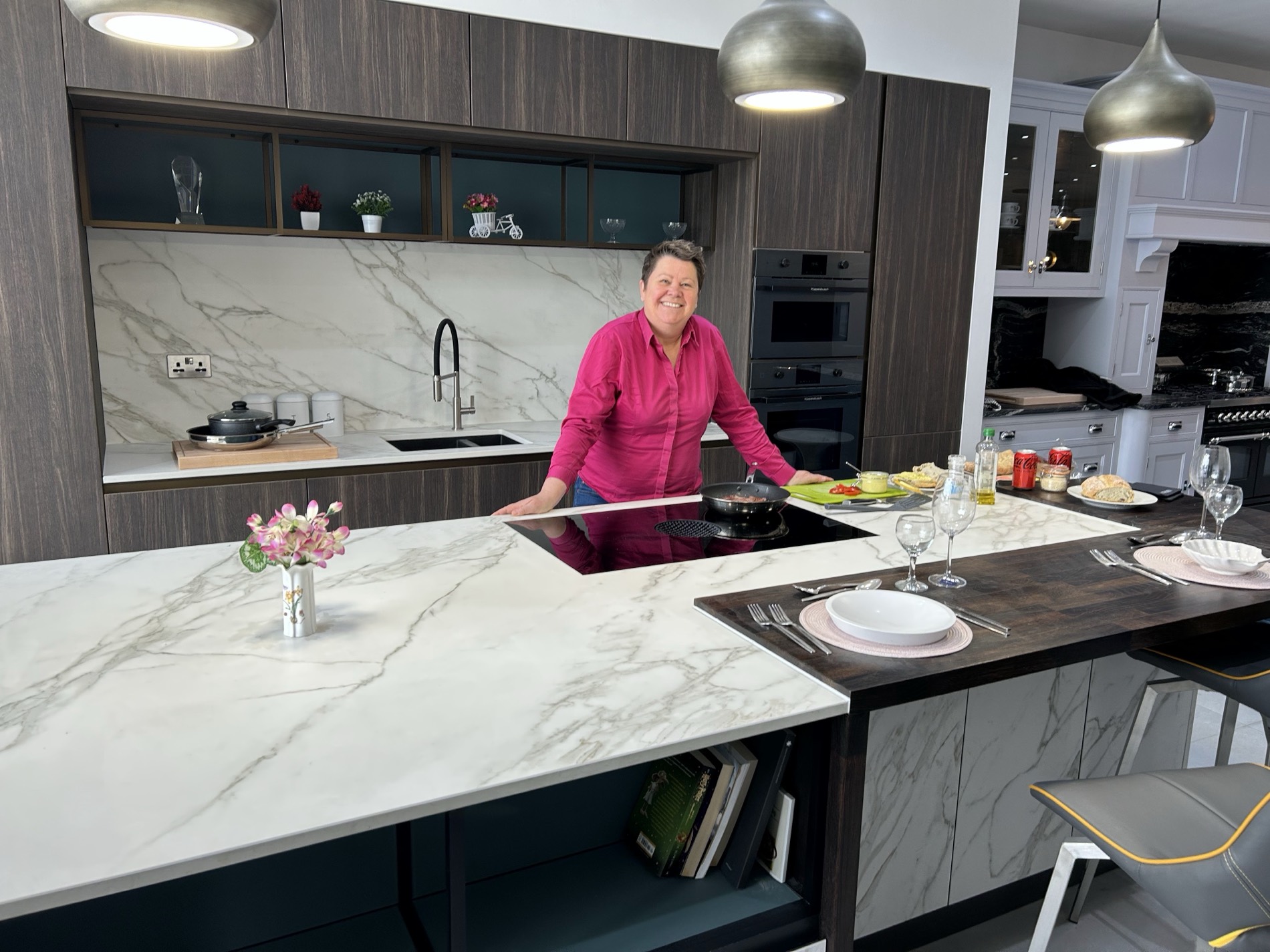 Our displays are set up as working kitchens rather than props — hobs, extraction, tall units and seating at the right heights, so you can stand at the worktop and see whether the layout actually suits you.
